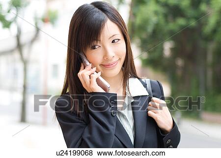 A mid adult woman using mobile phone View Large Photo Image Stock Photo - A mid adult woman using mobile phone. Fotosearch