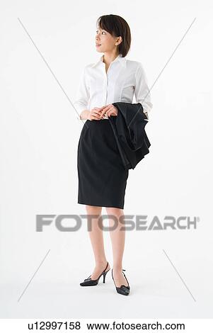 A mid adult woman wearing suit standing View Large Photo Image Stock Photo - A mid adult woman wearing suit standing. Fotosearch