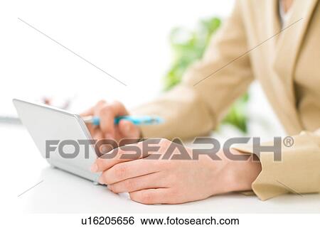 Stock Photograph - A woman using electronic dictionary, close-up. Fotosearch