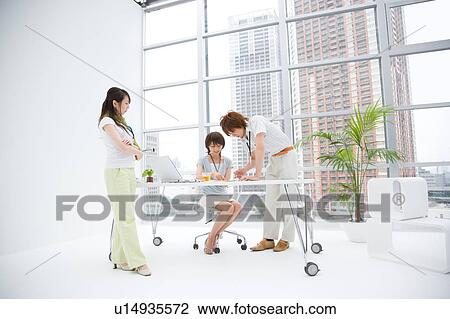Stock Image - Three people discussing. Fotosearch