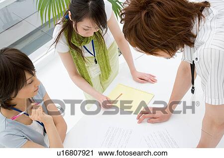 Three people discussing View Large Photo Image Stock Image - Three people discussing. Fotosearch
