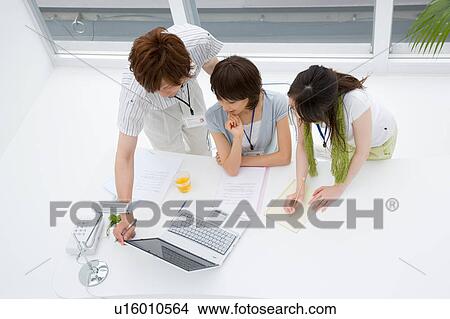 Three people looking at computer View Large Photo Image Picture - Three people looking at computer. Fotosearch