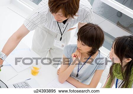Three people looking at computer View Large Photo Image Stock Photography - Three people looking at computer. Fotosearch