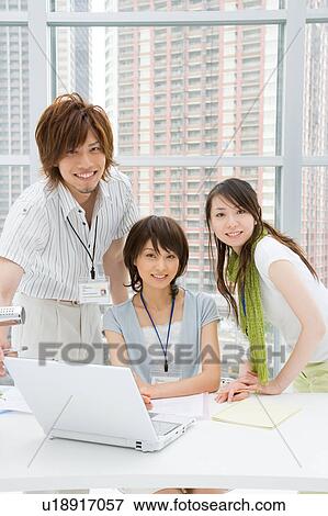 Stock Photo - Three young business people smiling. Fotosearch