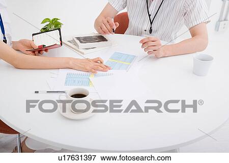 Stock Photo - Two people discussing. Fotosearch