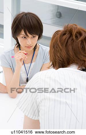 Stock Photograph - Two people discussing. Fotosearch