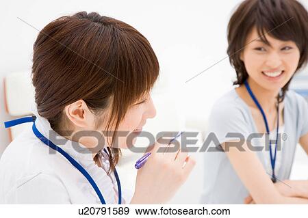 Stock Photo - Two young women smiling. Fotosearch