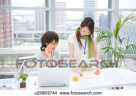 Two young women talking View Large Photo Image Picture - Two young women talking. Fotosearch
