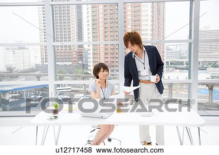 Stock Photo - Young woman and man discussing. Fotosearch