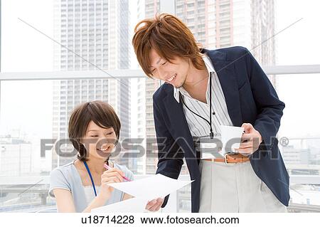 Stock Photo - Young woman and man discussing. Fotosearch
