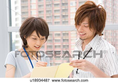 Stock Photo - Young woman and man discussing. Fotosearch