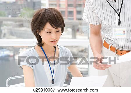 Young woman and man discussing View Large Photo Image Stock Photo - Young woman and man discussing. Fotosearch