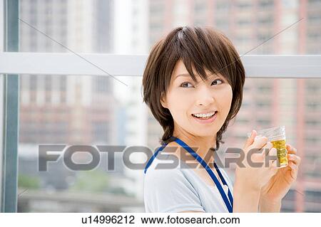 Young woman holding a cup of tea View Large Photo Image Stock Image - Young woman holding a cup of tea. Fotosearch
