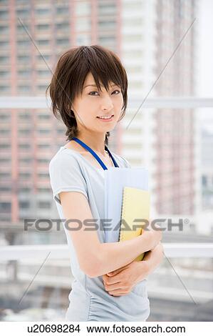 Picture - Young woman holding files. Fotosearch