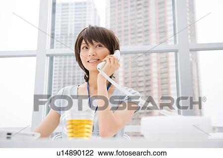 Young woman talking over phone View Large Photo Image Stock Image - Young woman talking over phone. Fotosearch