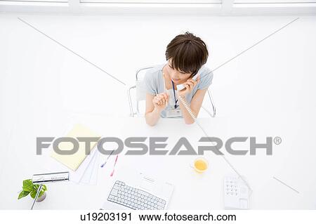 Young woman talking over phone View Large Photo Image Stock Image - Young woman talking over phone. Fotosearch