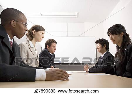 Stock Image - Business people having meeting. Fotosearch
