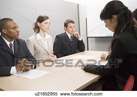 Stock Photography - Business people having meeting. Fotosearch
