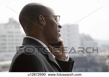 Stock Image - Businessman using mobile phone. Fotosearch
