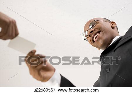 Stock Photo - Businessmen exchanging business cards. Fotosearch