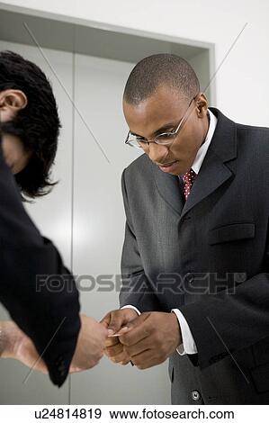 Stock Photo - Businessmen exchanging business cards. Fotosearch