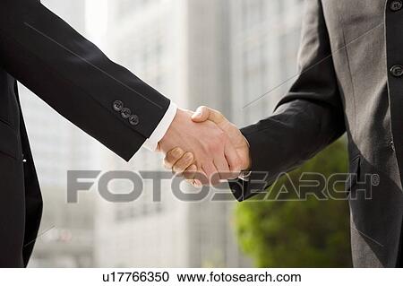 Stock Image - Businessmen shaking hands. Fotosearch