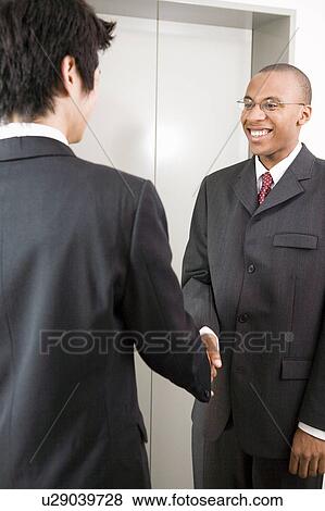 Stock Photo - Businessmen shaking hands. Fotosearch