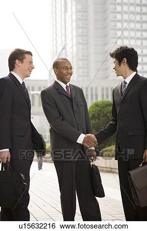 Stock Photograph - Businessmen shaking hands. Fotosearch