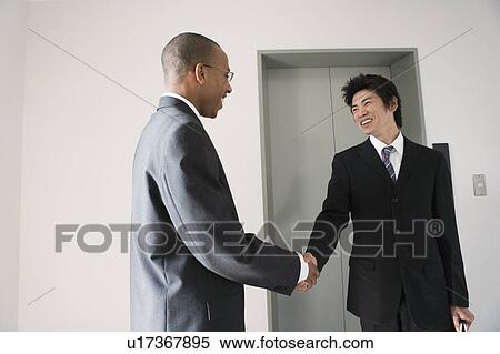 Stock Photography - Businessmen shaking hands. Fotosearch