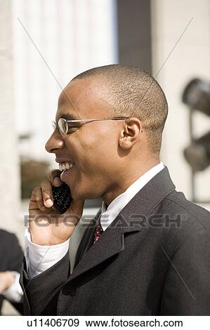 Businessmen using mobile phone View Large Photo Image Stock Photo - Businessmen using mobile phone. Fotosearch