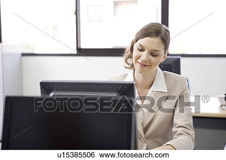 Stock Photograph - Businesswoman working on computer. Fotosearch