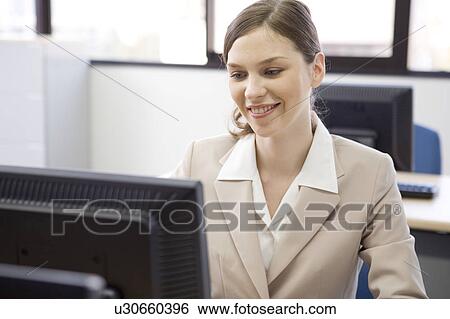 Stock Photograph - Businesswoman working on computer. Fotosearch