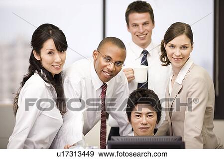 Stock Photo - Group of business people looking at camera. Fotosearch