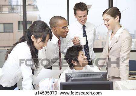 Stock Image - Group of business people working in office. Fotosearch