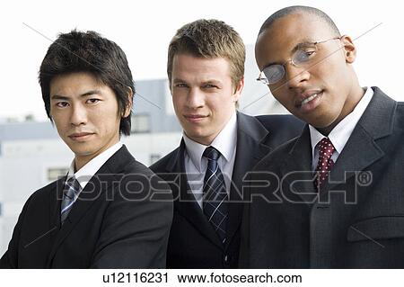 Stock Image - Three businessmen looking at camera. Fotosearch
