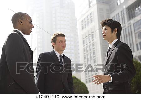 Three businessmen talking View Large Photo Image Stock Image - Three businessmen talking. Fotosearch