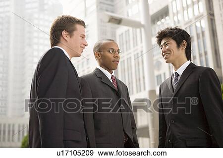 Three businessmen talking View Large Photo Image Stock Photo - Three businessmen talking. Fotosearch