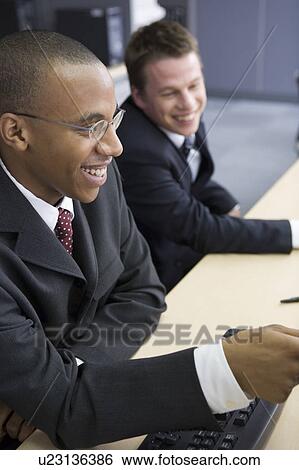 Stock Photograph - Two businessmen smiling. Fotosearch