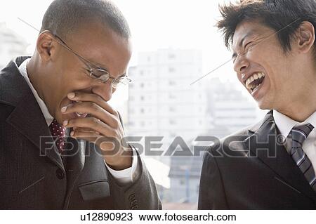 Two businessmen talking and laughing View Large Photo Image Stock Image - Two businessmen talking and laughing. Fotosearch