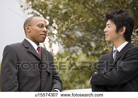 Stock Photo - Two businessmen talking. Fotosearch