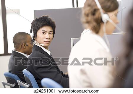 Young man working in call center View Large Photo Image Stock Image - Young man working in call center. Fotosearch