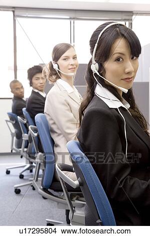 Picture - Young people working in call center. Fotosearch