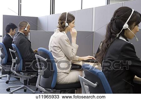 Stock Image - Young people working in call center. Fotosearch
