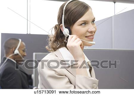 Young woman working in call center View Large Photo Image Stock Image - Young woman working in call center. Fotosearch