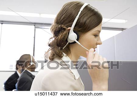 Young woman working in call center View Large Photo Image Stock Photo - Young woman working in call center. Fotosearch