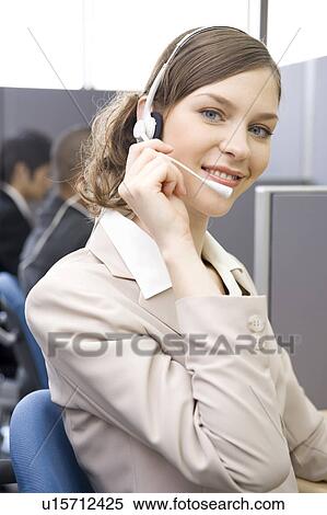 Young woman working in call center View Large Photo Image Stock Photography - Young woman working in call center. Fotosearch