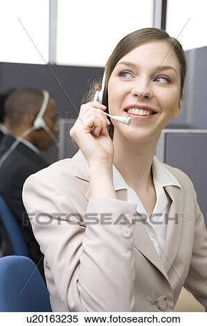 Young woman working in call center View Large Photo Image Stock Photography - Young woman working in call center. Fotosearch