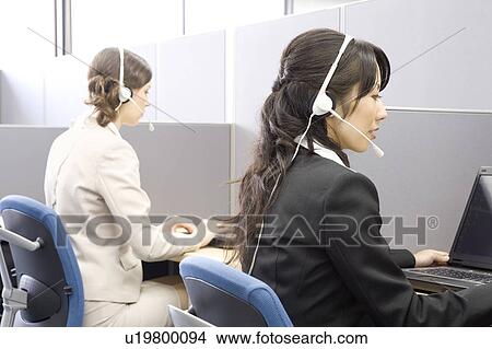 Picture - Young women working in call center. Fotosearch