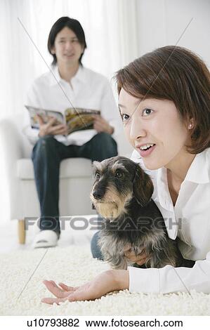 Stock Image - Young couple and Dachshund. Fotosearch