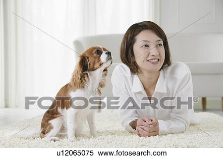 Stock Photography - Young woman and cavalier king Charles spaniel. Fotosearch